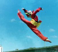 Black and white portrait of a dance instructor against a light background.